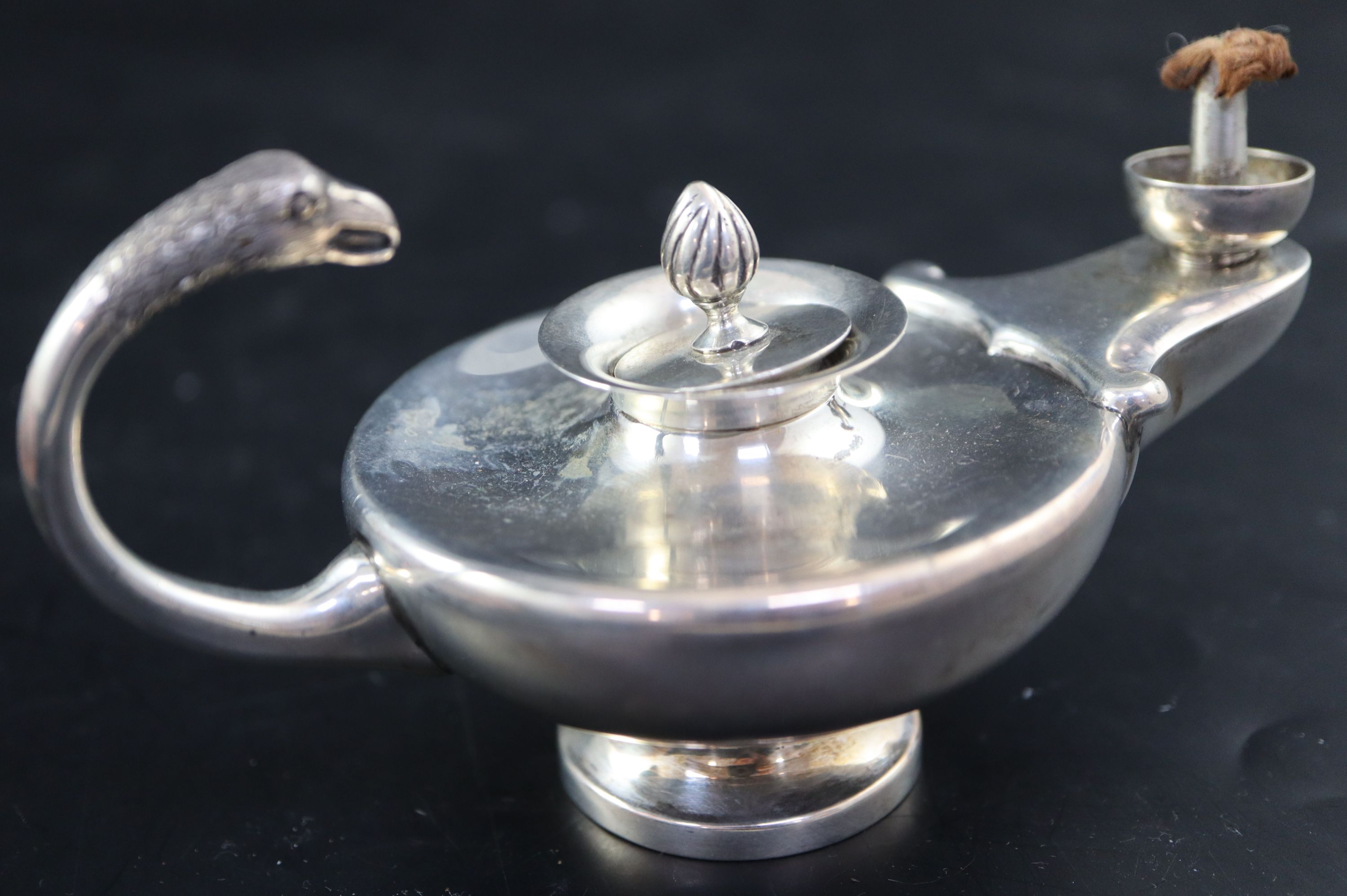 A George V silver Aladdins Lamp club lighter, length 13cm, gross 138 grams.